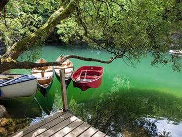 Luminous lake with row boats and canoes that can be used by guests