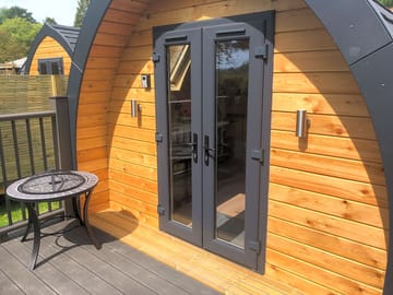 Terrace with a firepit outside of the double pod