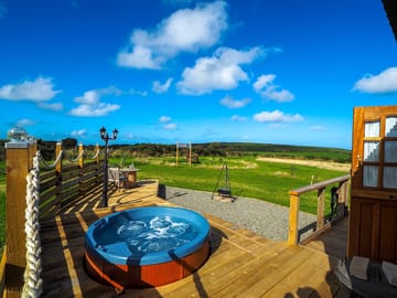 Decking surround with hot tub and lamp post.