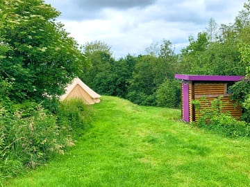 Deluxe bell tent with a private shower and toilet