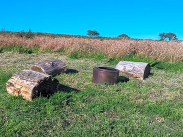 Each pitch comes with a firepit and a basket of logs