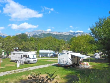 Level grass pitches with mountain views