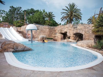 Tropical-themed pool with slides