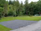 Hardstanding pitch with grass to the side