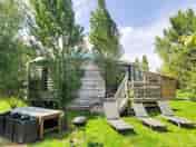 Exterior view of the 95m² Giant Yurt and its garden furniture/terrace