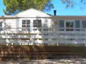 Static caravan with shaded outdoor deck