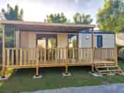 Partially covered terrace with wooden table and chairs