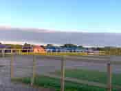 Outside the toilet block. Hard standing pitches on the right & tent pitches the other side of fence