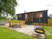 Patio with a woodfired hot tub and barbecue