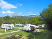 Level grass pitches with mountain views
