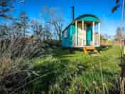 Dragonfly Shepherds Hut - lit by solar lights for a magical evening under the stars.