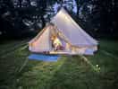 Bell tent all lit up at night