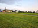 Some of the site including mobile home and caravan for hire. the blue building is 2 separate toilets