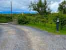 View looking out if site entrance, with dog exercise field to right.