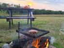 Bbq and bench within one of the pitches.