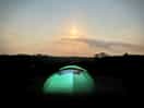 Our tent glowing below the moonlight.