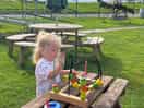 Enjoying the toys while waiting for breakfast