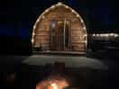 The log cabin with pretty lights whilst having a fire