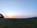 Sunset view over the sea, stood on top of a wall