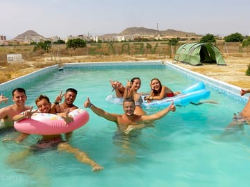 Guests enjoying the outdoor swimming pool