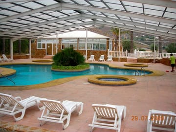 Swimming pool with sliding roof and solarium