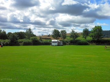 Grass electric pitch with hills as backdrop