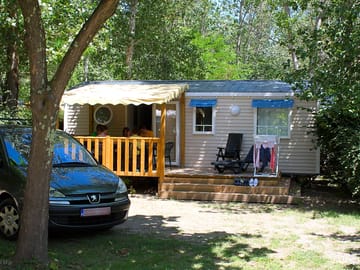 Outside the holiday home with view of the covered terrace and parking space