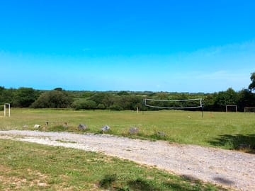 Communal sports field with volleyball court and football pitch