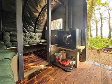 Extra spacious seating area with cosy log burner in saltings eden landpod only