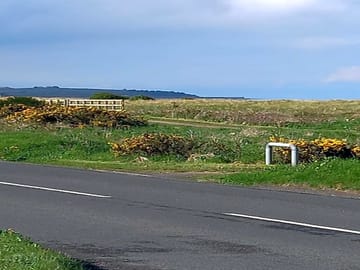 Cycle path with maryport harbour in the distance.
