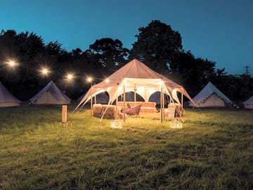 Chillout tent with games and hay bale seating