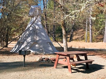 Each tipi has a picnic table, charcoal barbecue, firepit and water spout