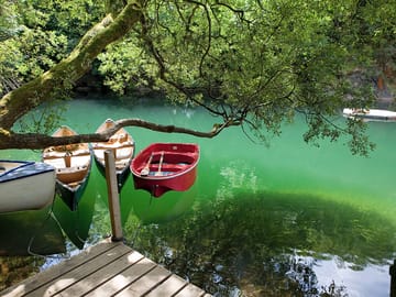 Luminous lake with row boats and canoes that can be used by guests