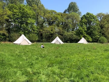 Bell tents on the riverside Meadow Camp