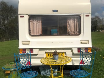 Rear end of the van with bistro table and chairs