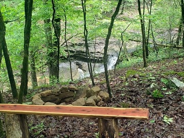 Firepit and bench provided on waterfalls pitches
