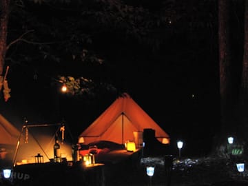 The tents lit at night