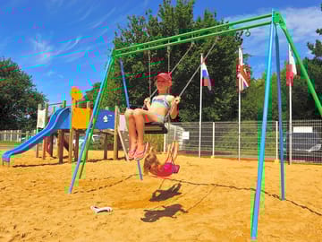 The playground with swings, a slide and outdoor toys