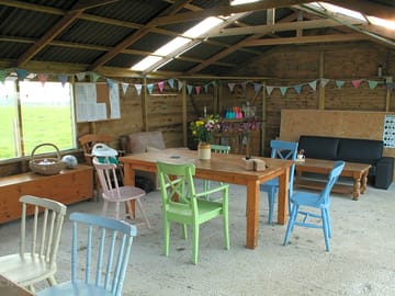 Gathering barn. dining and comfy chairs. bar area and kids toy chest