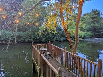 Private decking and table over pond.