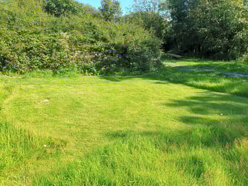 Grass and gravel tent pitch