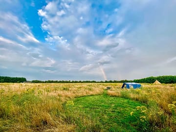 Camping pitch mown into the wild grass