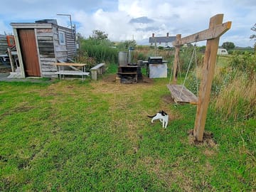 Utility area with benches and a swing, ideal for barbecues