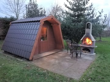 Glamping pod with lit chimenea