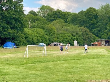The camping field is surrounded by woodland