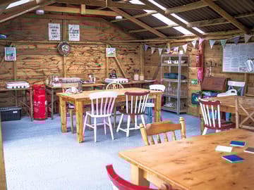 Gathering barn. cooking and dining area. including kids outdoor toys, books and games
