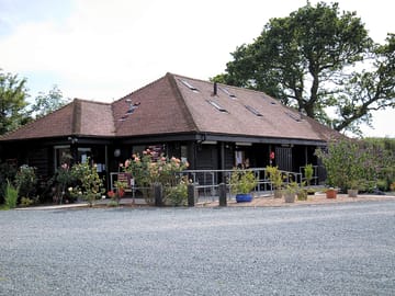 Main welcome cabin containing showers, toilets, disabled toilets, outdoor sinks, & utilities