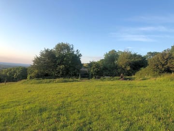 Camping field sheltered by trees