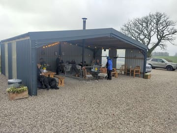 Open fronted cafe with log burner