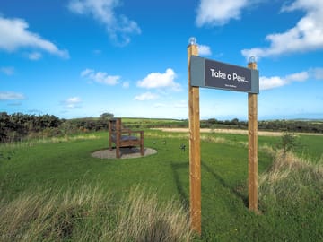 Giant bench, next to the hut, to relax and enjoy the distant sea views.